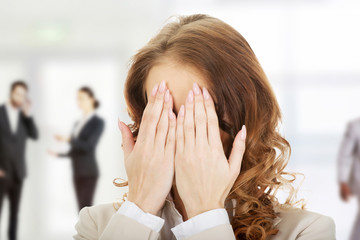 Businessman covering face by hand.