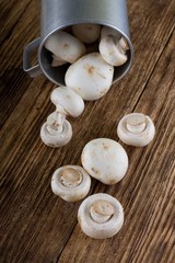 Several fresh champignons spilled from old cup