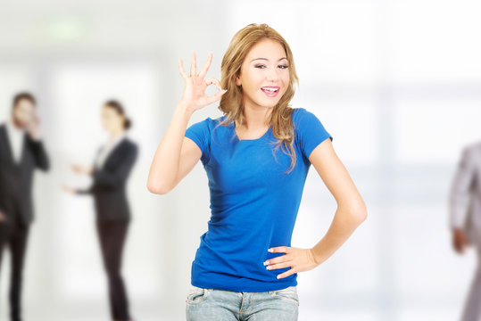 Young woman showing perfect sign.