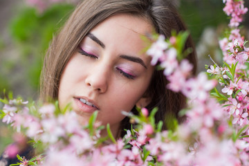 Fototapeta premium portrait of young beautiful girl in flowers