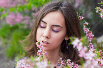 Fototapeta premium portrait of young beautiful girl in flowers