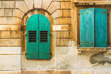 The wall and the green window shutters, mediterranian architectu