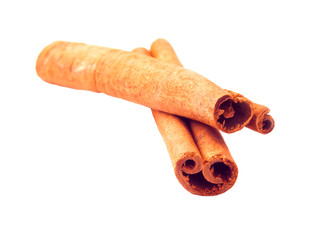 two cinnamon sticks closeup on a white background