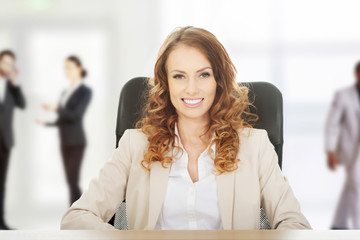 Businesswoman by a desk.