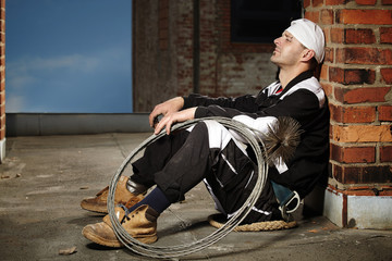 Chimney sweep man sitting on roof