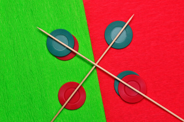 Red and green jetons with two sticks 