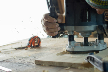Close-up of carpenter cutting a wooden plank. Selective focus. Copy space