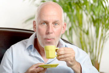 a middle-aged man drinking coffee