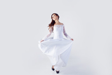 Naklejka premium Beautiful bride in wedding dress, white background