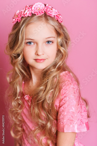 "Cute kid girl 10 years old posing over pink" Stock photo and royalty