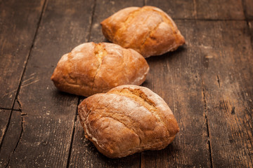 Artisan ciabatta bread over over ancient wooden table