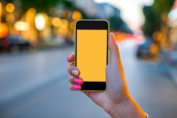 Holding phone on street background