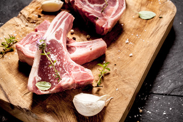 Raw Seasoned Lamb Filets on Rustic Wooden Board
