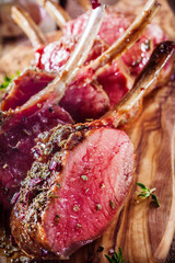 Rare Seasoned Lamb Chops on Wooden Cutting Board