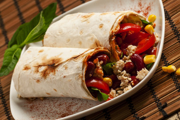 Traditional Mexican food, burritos with meat and beans, selectiv