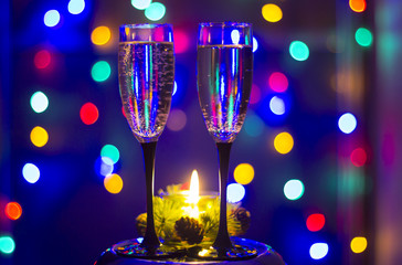Glasses of champagne and a candle