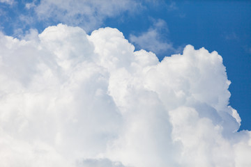 Naklejka na ściany i meble close up of white fluffy cumulus cloud in the blue sky