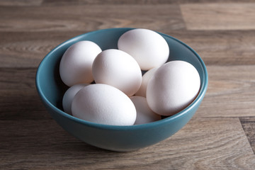 Eggs in bowl on table.