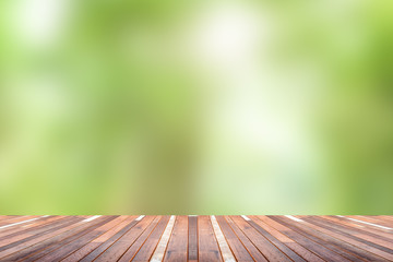 Green abstract blur nature background  with wooden floor