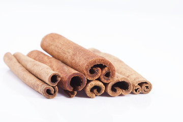 group of dried cinnamon stics on white background