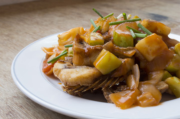 Sweet and sour fish fried on white dish