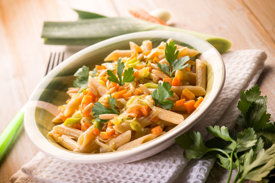 pasta with carrot leek and pine nuts, selective focus