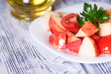 Salad tomato and apples. Vegan diet. Rustic.