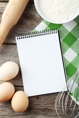 Open blank recipe book on grey wooden background