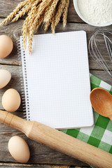 Open blank recipe book on grey wooden background