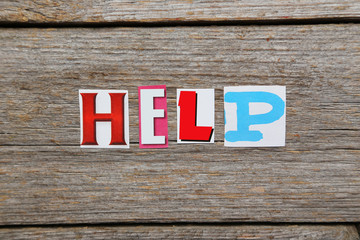 Fototapeta premium The word Help in cut out magazine letters