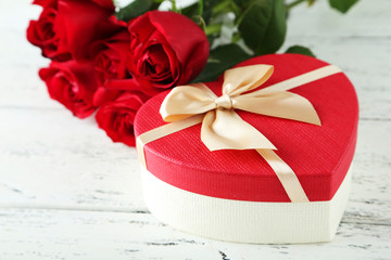 Beautiful heart gift box on white wooden background