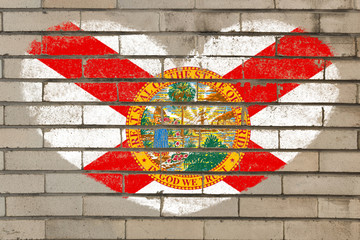 heart shape flag of florida on brick wall