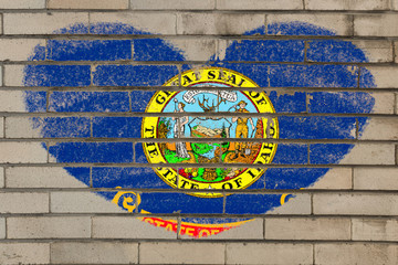 heart shape flag of idaho on brick wall