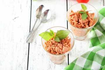 Glass with granita from fresh tomatoes on white wooden backgroun