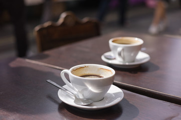 Two cups of coffee on table outside