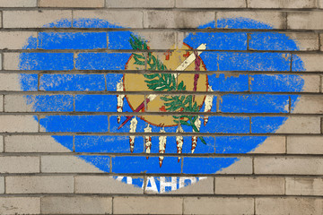 heart shape flag of oklahoma on brick wall