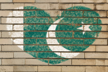 heart shape flag of Pakistan on brick wall