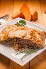 strudel stuffed with chopped meat pumpkin and herbs, selective focus