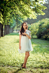 Naklejka na ściany i meble beautiful girl in a white dress on nature