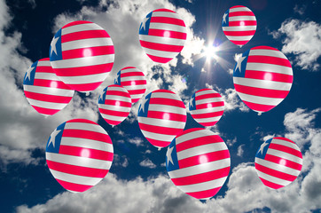 many balloons with liberia flag on sky