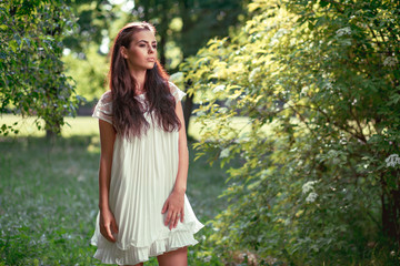 beautiful girl in a white dress on nature