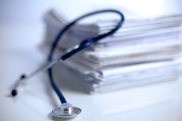 Medical stethoscope on the stack of paper