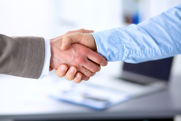 Fototapeta na wymiar Closeup of a business handshake, on white background