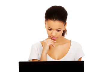 Teen woman using a laptop.