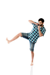 Young casual man kicking.