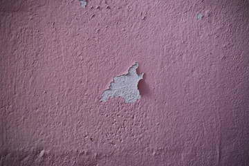 Old mortar wall with peeled plastered wall painted pink