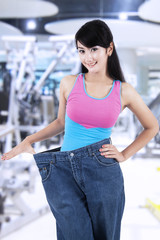 Pretty woman with old jeans at gym center
