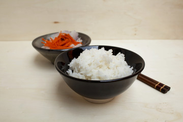 Close up rice in a black bowl with space on background