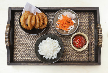 Onion ring with rice and vegetable salad on wood tray