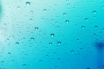 Water drop on glass mirror background.